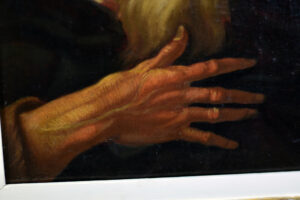 Close-up detail of the saint's hands in an 18th-century French or Italian school oil painting, showcasing the intricate brushwork and texture.